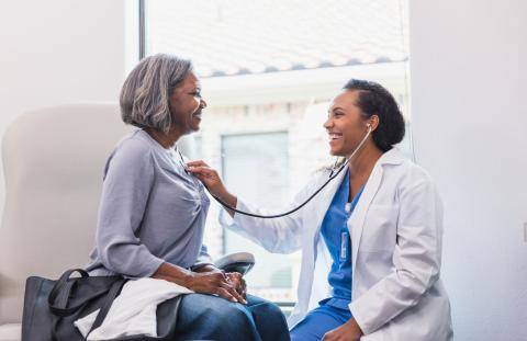 Doctor Checking Patient's Heartbeat with Stethoscope