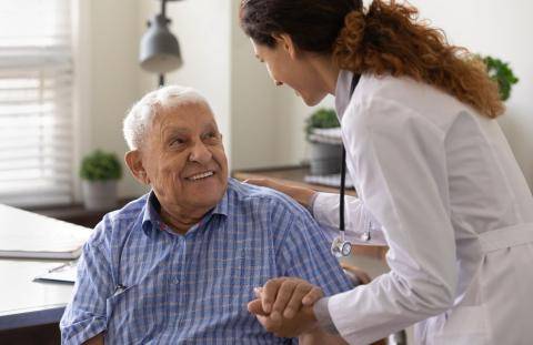 Doctor helping old man